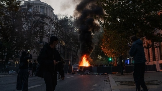 Violent clashes erupted across France as masked groups looted luxury stores, vandalised buildings and set vehicles on fire.