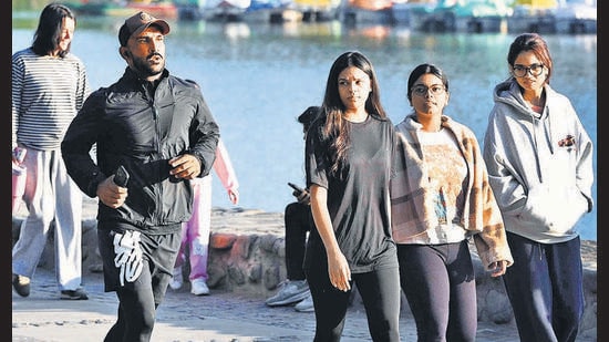 Residents during a morning walk amid a pleasant weather at Sukhna Lake on Sunday. (Keshav Singh/HT)