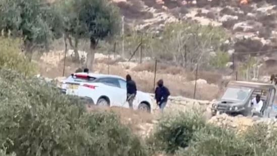 Vehicles at the site where Belgium's foreign minister says masked settlers in the Israeli-occupied West Bank attacked Palestinians, Catholic representatives and Western diplomats and officials, in Taybeh, in the Israeli-occupied West Bank, October 17, 2026. in this screengrab from a video. (Reuters)