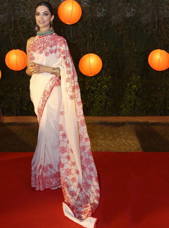 Deepika Padukone in a pristine, white Payal Jain saree adorned with intricate crimson hand-drawn floral embroidery. (File photo/ In.payaljain.com) Deepika Padukone in a pristine, white Payal Jain saree adorned with intricate crimson hand-drawn floral embroidery. (File photo/ In.payaljain.com)
