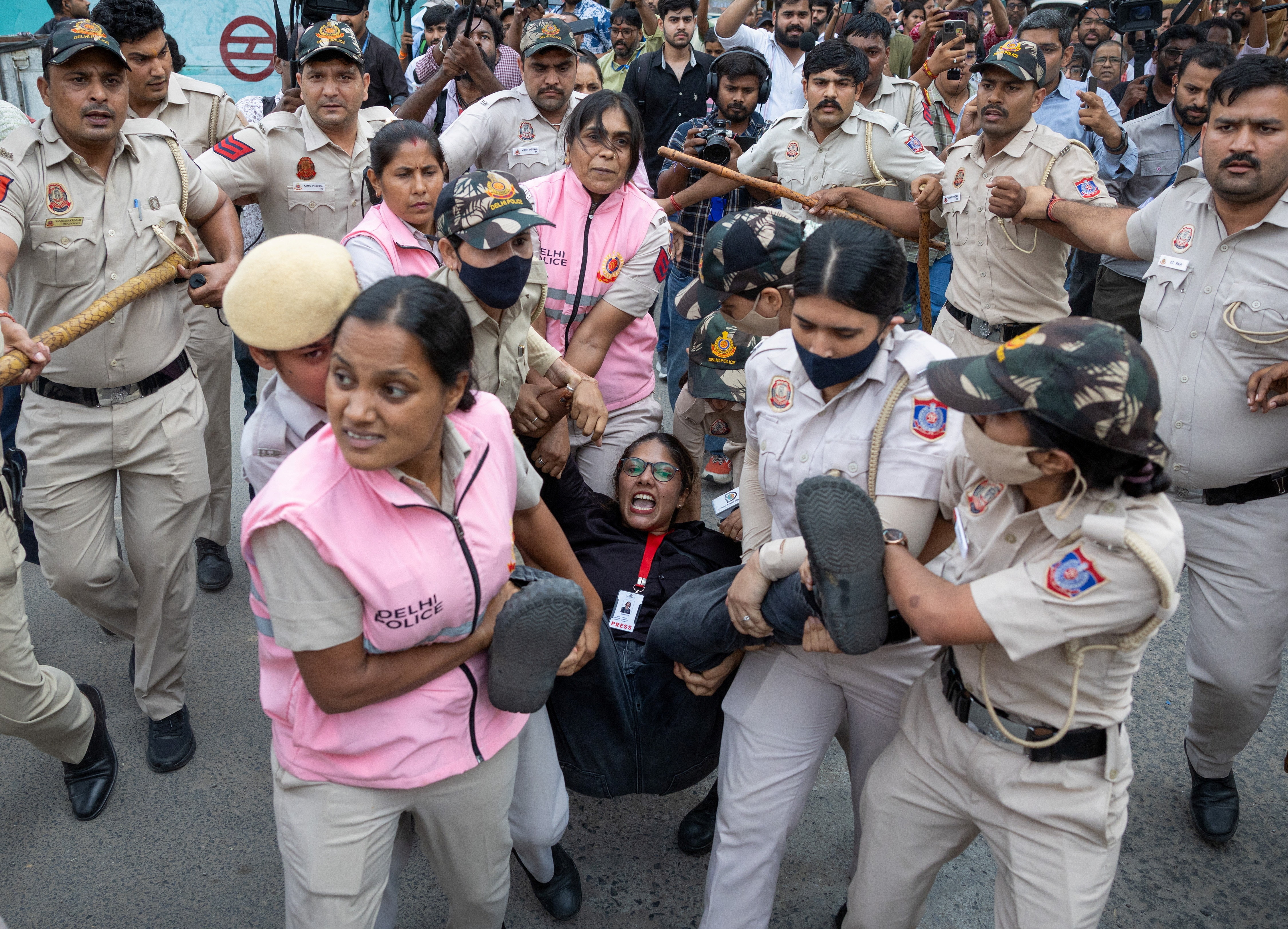 Hauled off: A woman identified by Reuters as a journalist detained by Delhi police. (Reuters/Adnan Abid)