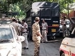 Police personnel stand guard near the police vehicle that brought CJP leaders Saurav Das and Ashutosh Ranka to appear before the Special Executive Magistrate (SEM) at the Mandir Marg police station, in New Delhi on Monday.