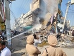 Anger boils over in Mansa town on October 14 as protesters burn down a chemist shop, where anti-drug activist Parvinder Singh Jhota was fatally shot a day earlier. (HT file photo)