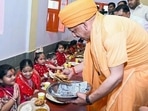 CM Yogi Adityanath serves food during Kanya Pujan on the occasion of Maha Navami at Gorakhnath temple, in Gorakhpur on Monday. (ANI)
