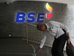 A man touches the stairs as he arrives at the Bombay Stock Exchange (BSE) building in Mumbai