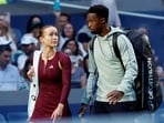 France's Gael Monfils and Ukraine's Elina Svitolina walk onto the court before their mixed doubles semi final match against Switzerland's Belinda Bencic and Italy's Flavio Cobolli