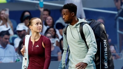France's Gael Monfils and Ukraine's Elina Svitolina walk onto the court before their mixed doubles semi final match against Switzerland's Belinda Bencic and Italy's Flavio Cobolli (REUTERS)