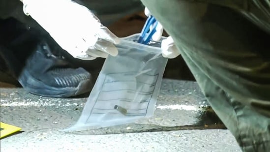 A forensic team collects samples from the spot where shots were fired at actor Tiger Shroff in Mumbai on Sunday. The actor is safe and has not sustained any gunshot injuries.