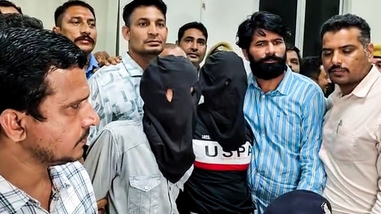 A visual of two of the three accused arrested by Kota Police in connection with the actor Tiger Shroff firing case, in Kota on Monday. The apprehended accused will be handed over to Mumbai Police. (ANI Video Grab)