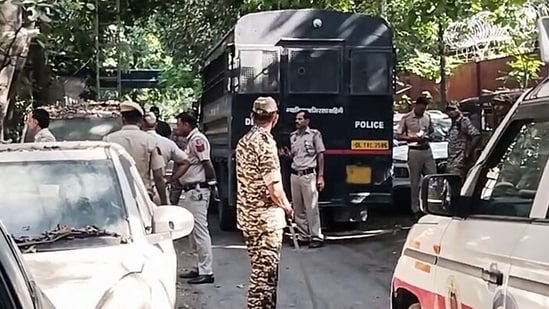 Police personnel stand guard near the police vehicle that brought CJP leaders Saurav Das and Ashutosh Ranka to appear before the Special Executive Magistrate (SEM) at the Mandir Marg police station, in New Delhi on Monday.