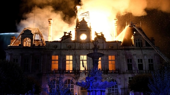 This photograph shows a fire burning and destroying the city hall after a group of individuals forced entry into the building during ongoing protest action against the "high cost of living", in Limoges, central France on October 17, 2026. (Photo by PASCAL LACHENAUD / AFP)