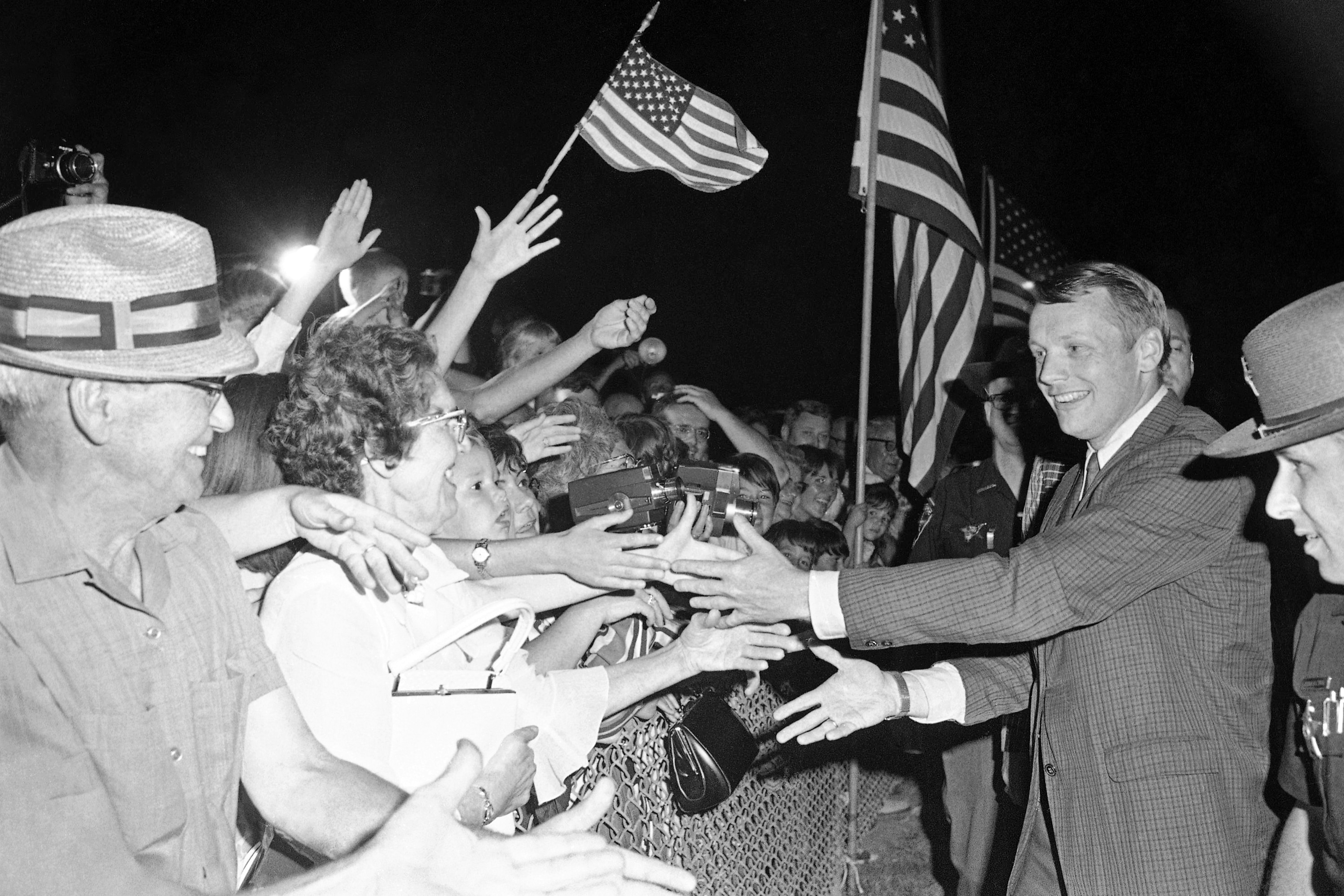 FILE - Astronaut Neil Armstrong, the first man to walk on the moon, shakes hands with the crowd at the Allen County Airport, Sept. 5, 1969, in Lima, Ohio. (AP Photo/CEK, File) (AP Photo/CEK)