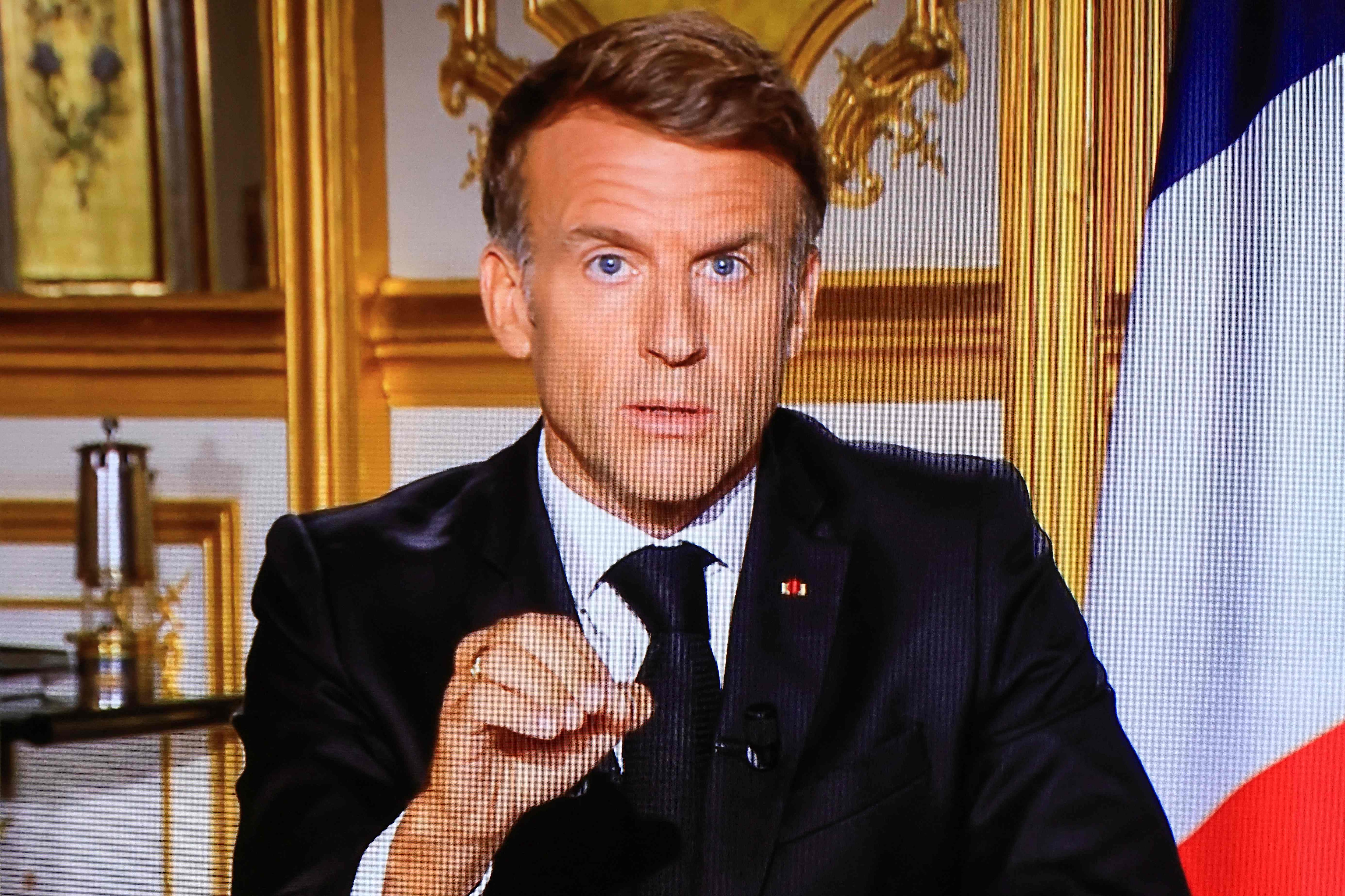 This photograph shows a television monitor broadcasting France's President Emmanuel Macron giving a speech from the Elysee Presidential Palace. (Photo by Ludovic MARIN / AFP) (AFP)