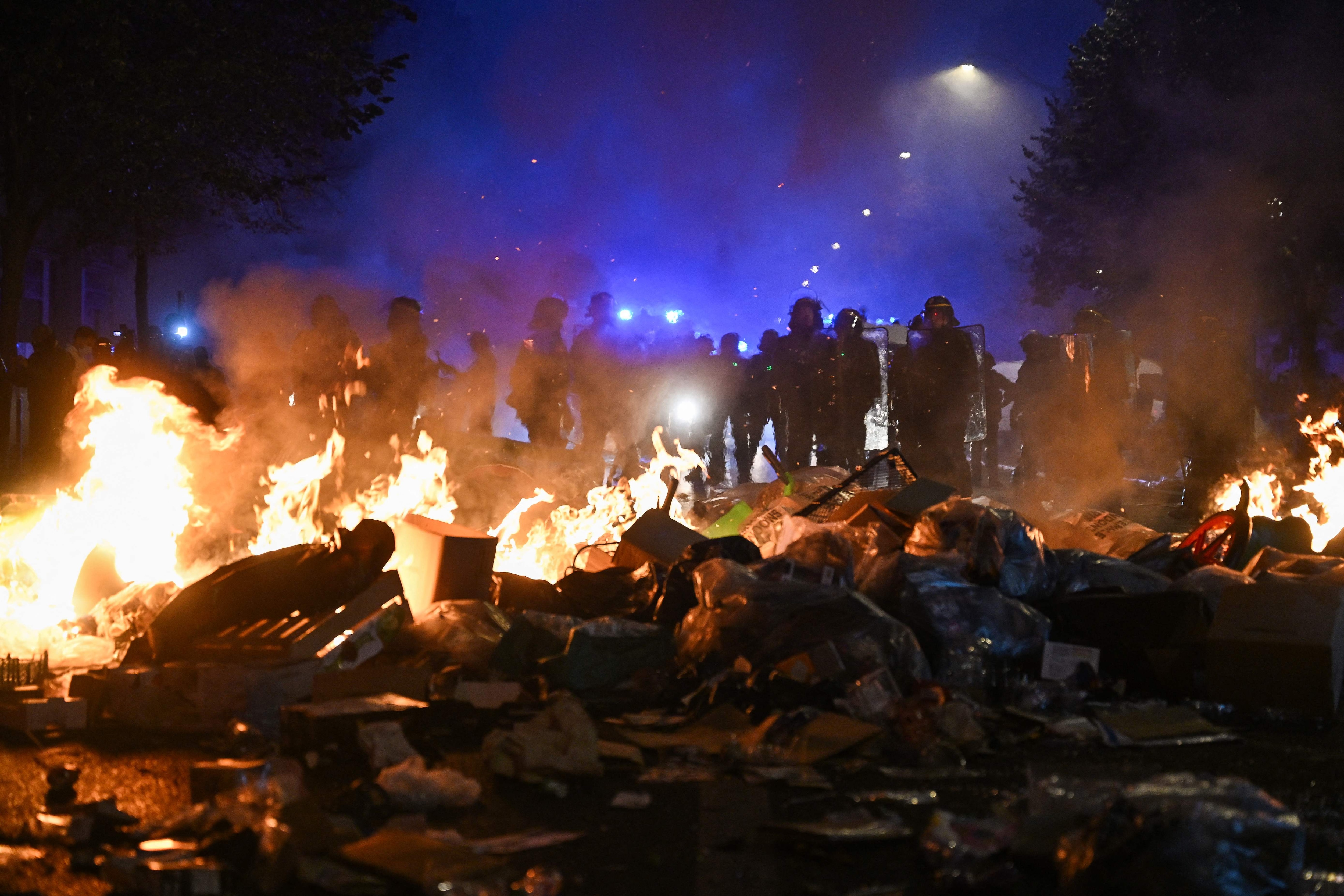 Multiple blazes gripped France as nationwide marches against soaring inflation degenerated into street violence of "extreme intensity". (Photo by Matthieu RONDEL / AFP) (AFP)