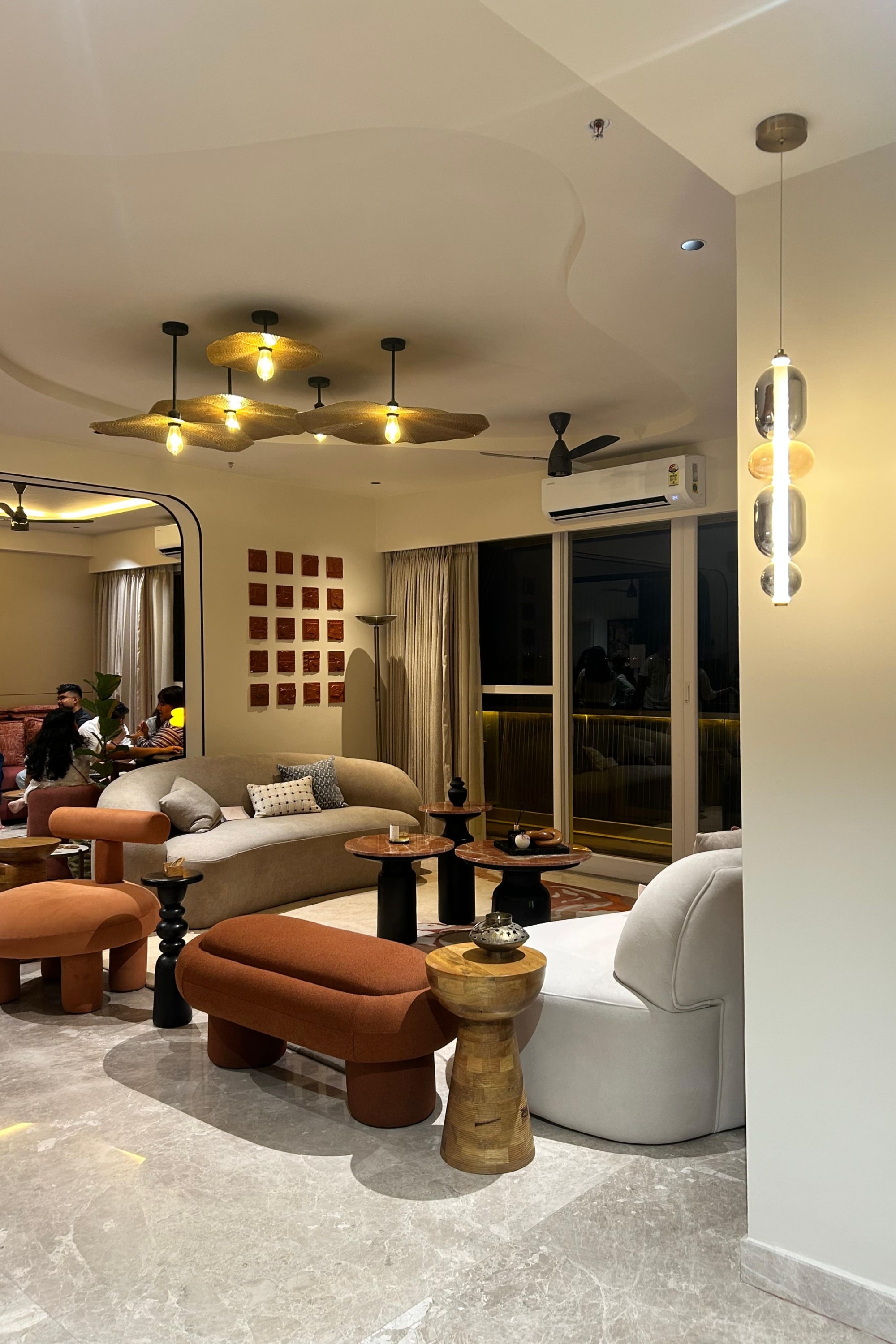 The After Hours living room: sculptural seating, soft lighting, and intentional calm.