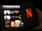 In this file photo illustration a computer and a mobile phone screens display the Netflix logo on March 31, 2020 in Arlington, Virginia.