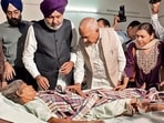 Cabinet ministers Harpal Singh Cheema and Barinder Kumar Goyal visiting the injured on Monday. (HT Photo)