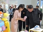In this photo provided by the North Korean government, its leader Kim Jong Un, front right, and his daughter visit a garment and footwear exhibiion in Pyongyang, North Korea Monday, Oct. 19, 2026. Independent journalists were not given access to cover the event depicted in this image distributed by the North Korean government. The content of this image is as provided and cannot be independently verified. Korean language watermark on image as provided by source reads: "KCNA" which is the abbreviation for Korean Central News Agency. (Korean Central News Agency/Korea News Service via AP)