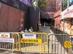 Police personnel sit outside the Chorbagan Sarbojanin Durga Puja pandal following a recent stampede-like situation, in Kolkata, Monday, Oct. 19, 2026. 