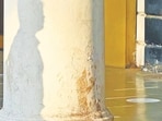 The man’s shadow falls on one column, his head and shoulders appearing clearly on the plaster.