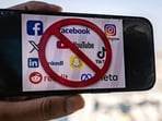 The logos of social media apps with a prohibition sign.(AFP)