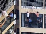 A toddler narrowly escaped a fall from a 12th-floor apartment in China after neighbours and firefighters rushed to her rescue.