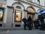 Police officers patrol as luxury shops remain closed at the Via Monte Napoleone street in Milan, Italy on Monday, a day after rioters clashed with police, looted stores and set property on fire.(AP Photo/Luca Bruno)