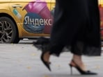 A woman walks past a Yandex-branded car in Moscow, Russia, October 13, 2026. REUTERS/Ramil Sitdikov