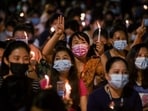 The Hunger Games' three-finger salute: People hold candles as they take part in an anti-coup night protest at Hledan junction in Yangon, Myanmar, March 14, 2021. 