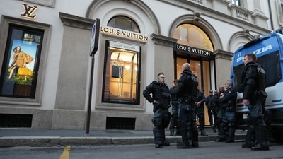 Police officers patrol as luxury shops remain closed at the Via Monte Napoleone street in Milan, Italy on Monday, a day after rioters clashed with police, looted stores and set property on fire. (AP Photo/Luca Bruno) Police officers patrol as luxury shops remain closed at the Via Monte Napoleone street in Milan, Italy on Monday, a day after rioters clashed with police, looted stores and set property on fire. (AP Photo/Luca Bruno)