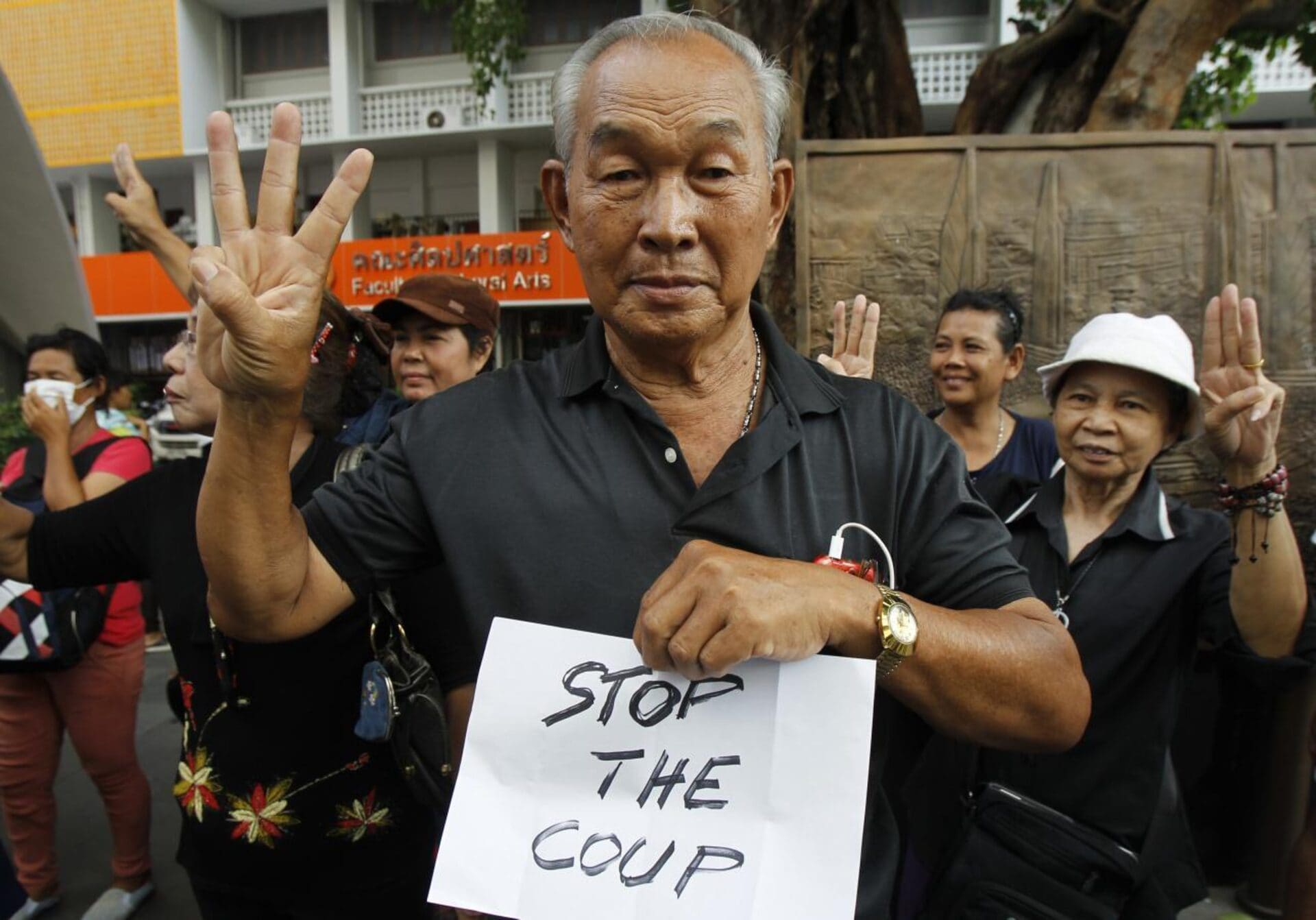 A protester gestures and holds up a sign during a brief protest against military rule at Thammasat University in Bangkok June 1, 2014. (REUTERS/Chaiwat Subprasom) A protester gestures and holds up a sign during a brief protest against military rule at Thammasat University in Bangkok June 1, 2014. (REUTERS/Chaiwat Subprasom)