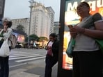 People use mobile phones as they wait for public transportation, as smartphone theft has become part of Brazil's electoral debate, in Sao Paulo, Brazil.