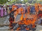 Protesters burning effigies of political leaders in Imphal East. (PTI)