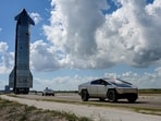Tesla Cybertrucks lead the way as the SpaceX Starship spacecraft rolls out toward the launch pad before its 11th test flight from the company's complex in Starbase, Texas, US.