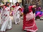 Women celebrate after 'Sindoor Khela' ritual on the occasion of 'Vijayadashami', the final day of the 'Durga Puja' festival, at a pandal, in Kolkata, West Bengal, Wednesday.