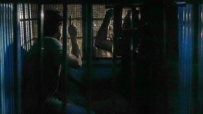 A police vehicle carrying Cockroach Janta Party leaders Saurav Das and Ashutosh Ranka leaves the Mandir Marg police station, in New Delhi, Wednesday, Oct. 21, 2026. (PTI)