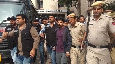 Gangster Lawrence Bishnoi is escorted by police personnel before being produced in Panchkula Court, Haryana, in 2019. (HT file) Gangster Lawrence Bishnoi is escorted by police personnel before being produced in Panchkula Court, Haryana, in 2019. (HT file)