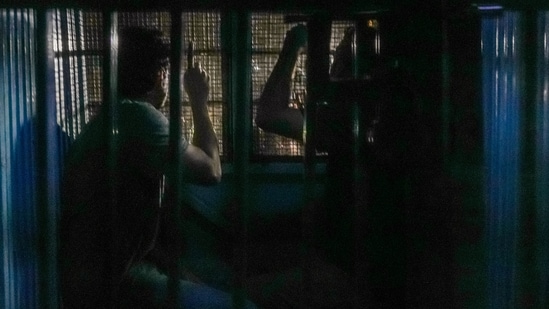 A police vehicle carrying Cockroach Janta Party leaders Saurav Das and Ashutosh Ranka leaves the Mandir Marg police station, in New Delhi, Wednesday, Oct. 21, 2026. 