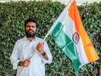 Former BJP leader and We The Leaders Foundation Chief Mentor K Annamalai holds the Indian national flag.