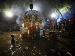 Devotees arrive to immerse a clay idol of Goddess Durga in an artificial pond on the banks of the Gomti river (Deepak Gupta/HT)
