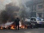 A French police officer extinguish burning bicycles during a demonstration against the cost of living and rising fuel prices in Paris, France, October 17, 2026.   