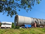 Escorted by police personnel, three red-flagged pilot vehicles and a 40-member technical crew tasked with lifting overhead power cables and pruning roadside trees, the convoy was stationed at Chhauchh village along National Highway 730A on Wednesday before making its final push to Kumbhi on Thursday morning. (Sourced)