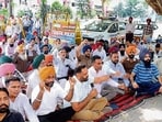 Government employees and pensioners protesting outside the DC office in Ludhiana on Wednesday. (Gurpreet Singh/HT)