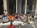 The students, who were protesting at the entrance of the campus, have shifted to a spot outside the director’s office
