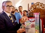 Jammu and Kashmir Chief Minister Omar Abdullah poses for a picture, holding the medals during the inauguration of Kashmir Marathon 2.0 Expo at Polo Ground, in Srinagar on Thursday. (ANI)