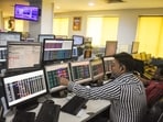 Share brokers track market movements on their computer screens at a trading office, in Kolkata.(ANI)