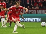Bayern Munich's English forward #09 Harry Kane scores the 2-1 goal from the penalty spot during the UEFA Champions League football match between FC Bayern Munich and Arsenal FC in Munich