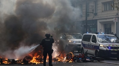 A French police officer extinguish burning bicycles during a demonstration against the cost of living and rising fuel prices in Paris, France, October 17, 2026. (REUTERS)