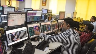 Share brokers track market movements on their computer screens as the Sensex and Nifty. (ANI)
