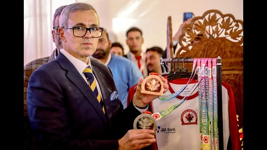 Jammu and Kashmir Chief Minister Omar Abdullah poses for a picture, holding the medals during the inauguration of Kashmir Marathon 2.0 Expo at Polo Ground, in Srinagar on Thursday. (ANI)